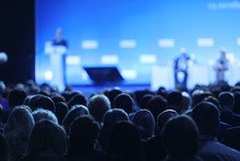 blurry photo of heads in the audience of an anonymous conference